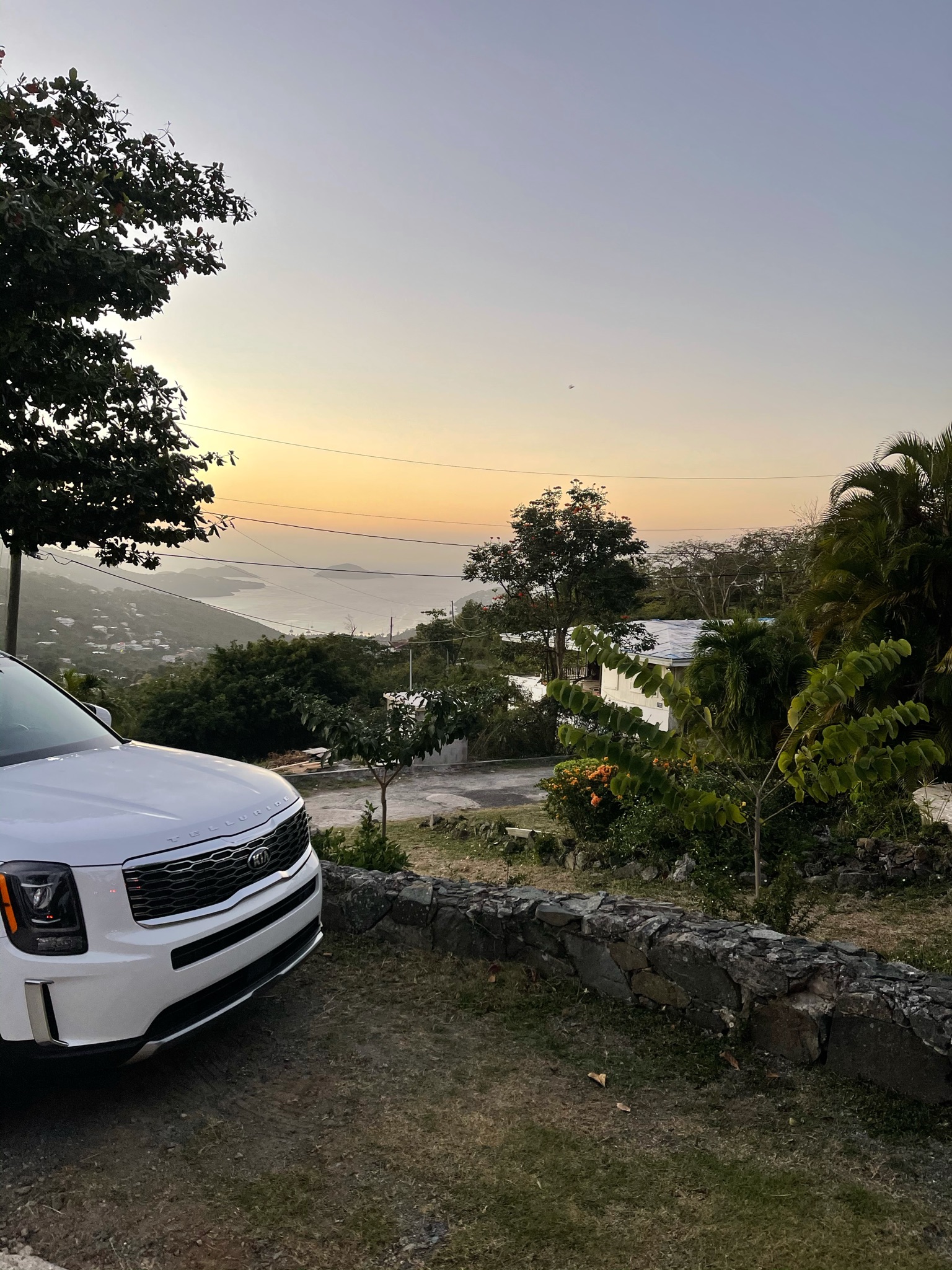 White car over looking Magens bay beach sunset