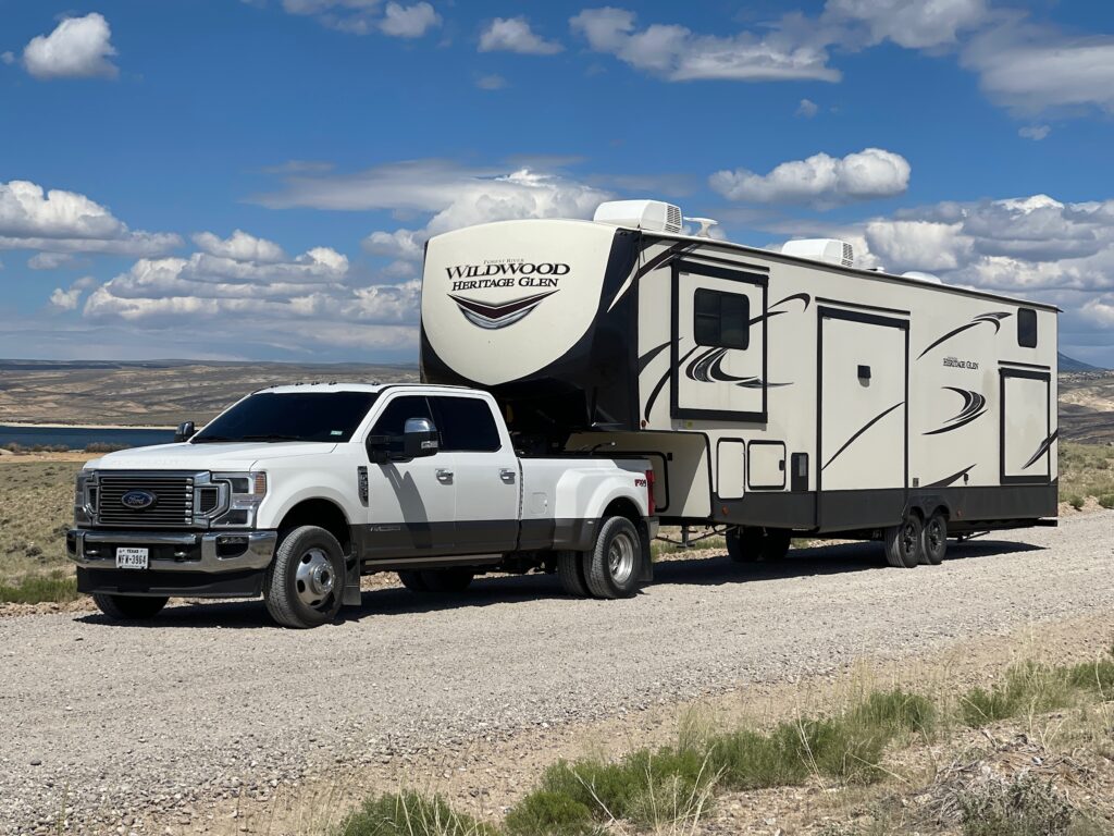 White Ford F-350 pulling a Wildwood Heritage Glen 378FL 5th wheel at Flaming Gorge in Wyoming