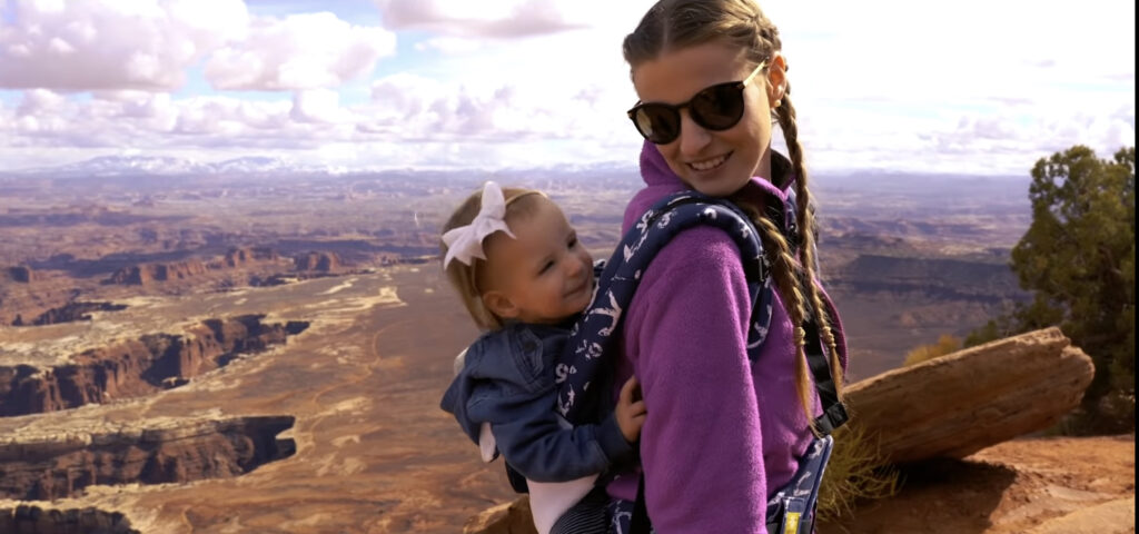 Baby wearing mom looking out on a hike in Utah